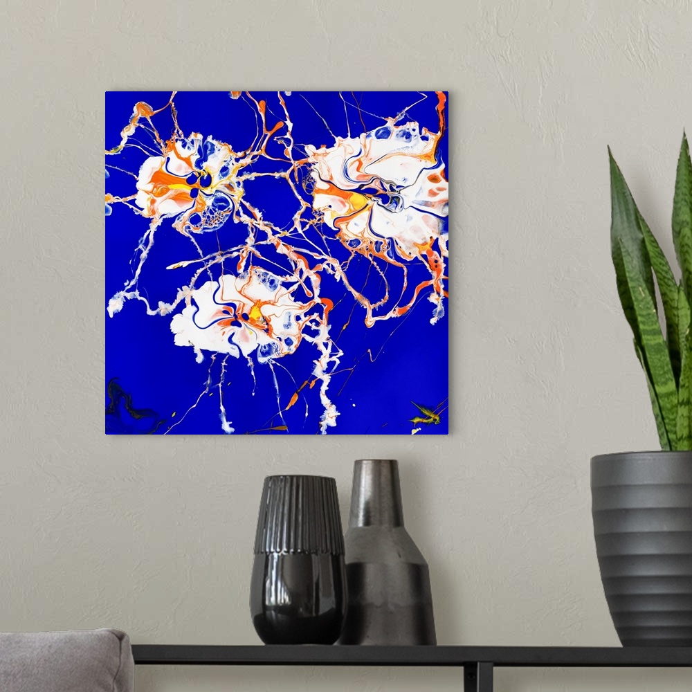 A modern room featuring Floral painting in pouring technique using white, orange and yellow paint on a contrasting backgr...