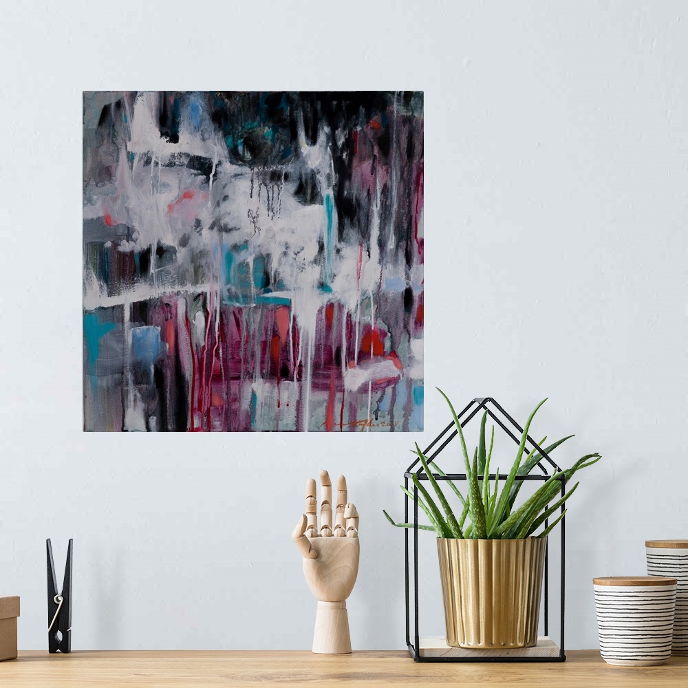 A bohemian room featuring An abstract painting of a play of warm and cool colors.