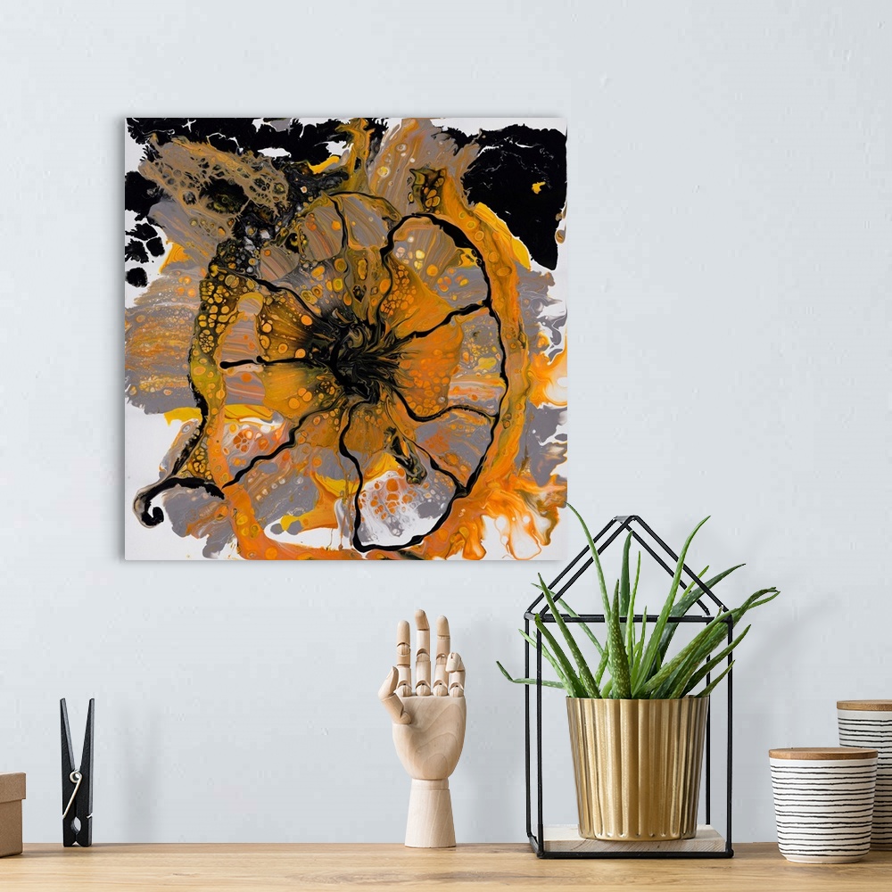 A bohemian room featuring Pour painting of a cowslip flower in orange and black colors on a background of primarily gray.