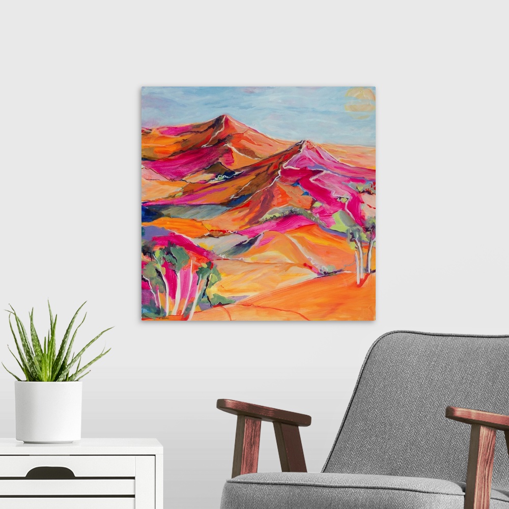 A modern room featuring A painting of the outback in bright reds and pinks.