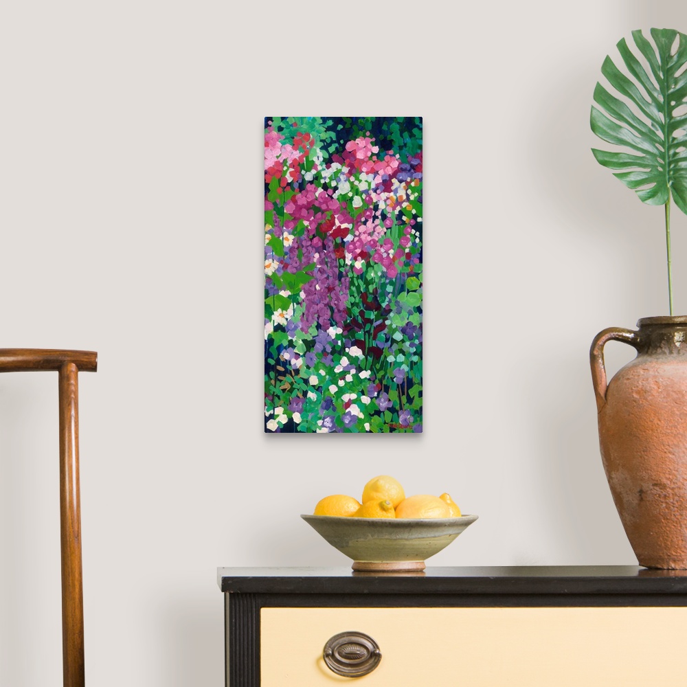 A traditional room featuring Tall narrow painting of flowers in a garden with daisies and red and purple spired blooms.