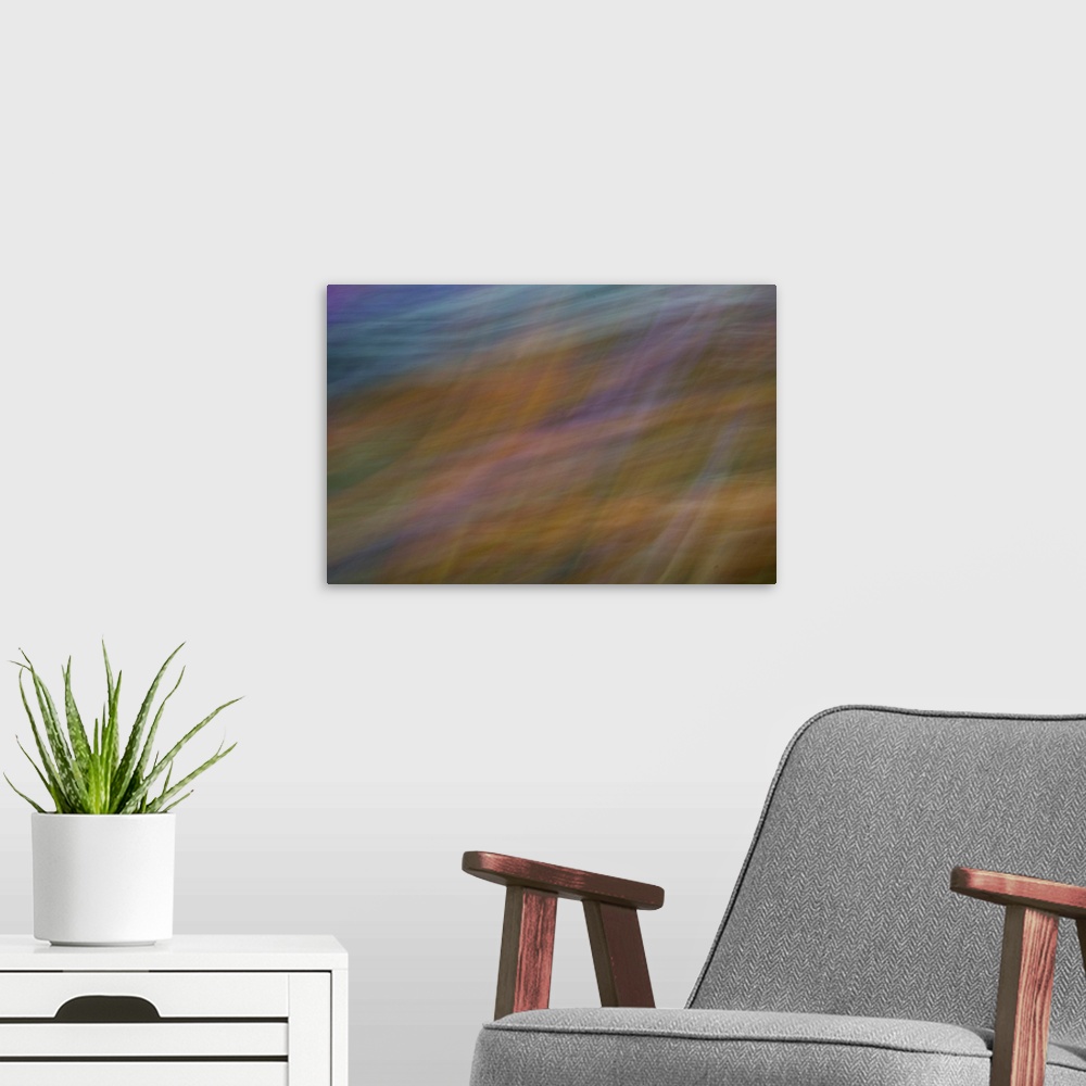 A modern room featuring Impressionist photograph of a garden with a combination of warm colors.