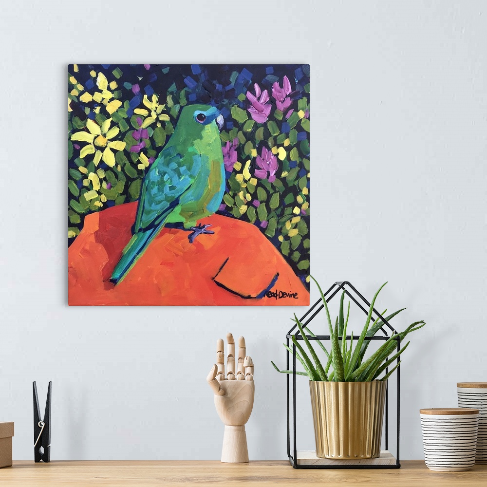 A bohemian room featuring NaAve painting of green parrot sitting on an orange rock with a background of flowers.