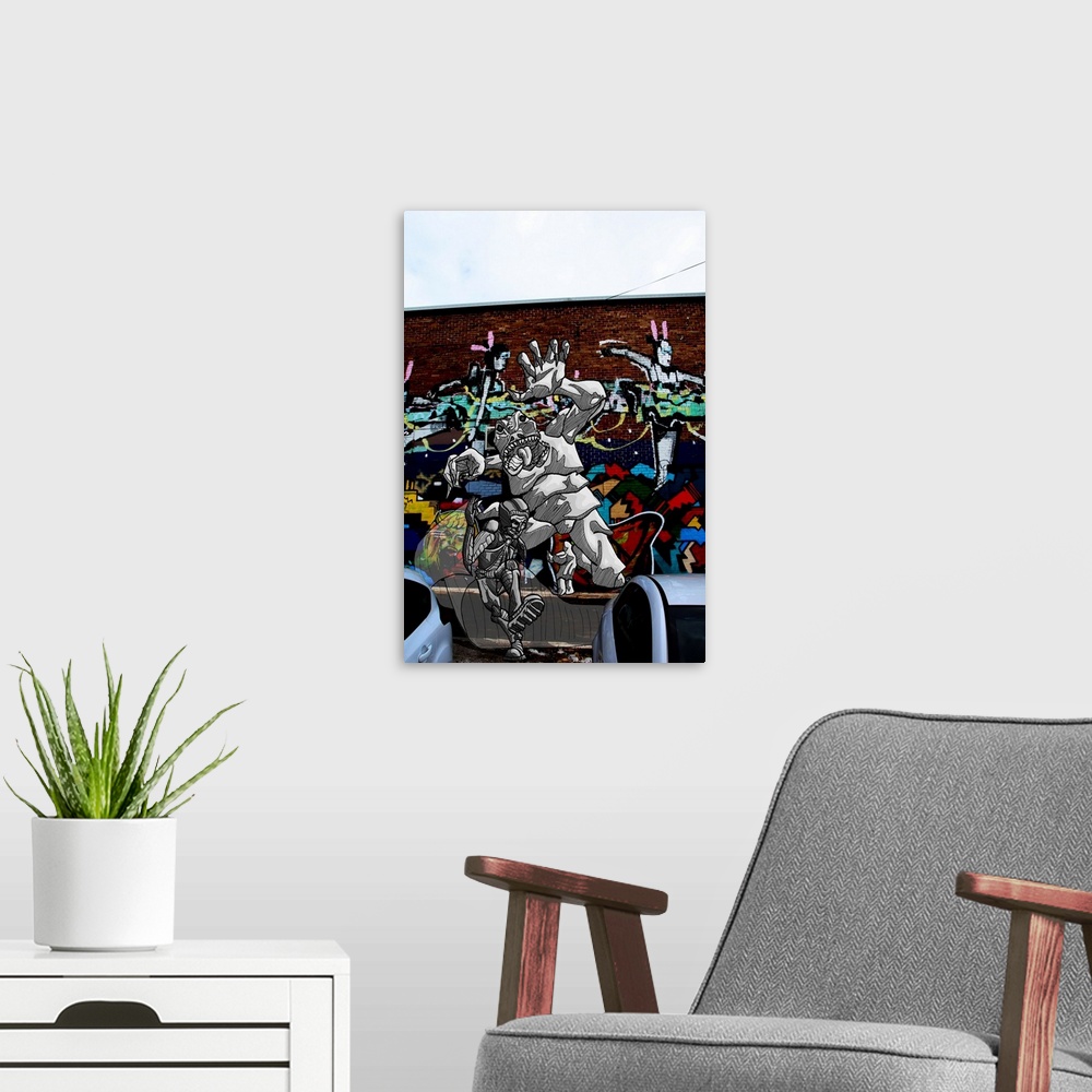 A modern room featuring Graffiti photograph with illustration of a superhero running away from a monster.