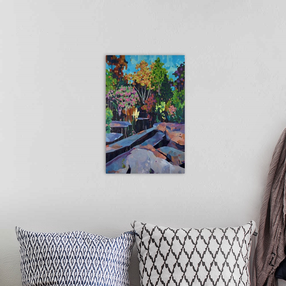 A bohemian room featuring Painting of many colored trees with still water, reflections and rocks.