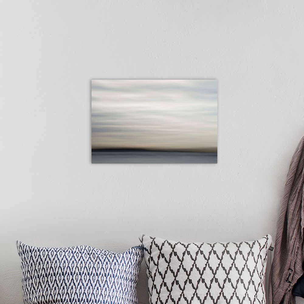 A bohemian room featuring Impressionist photograph by the seaside.