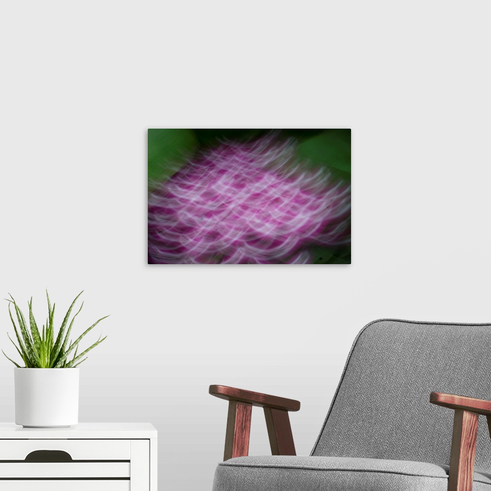 A modern room featuring Impressionist photograph of a group of flowers.