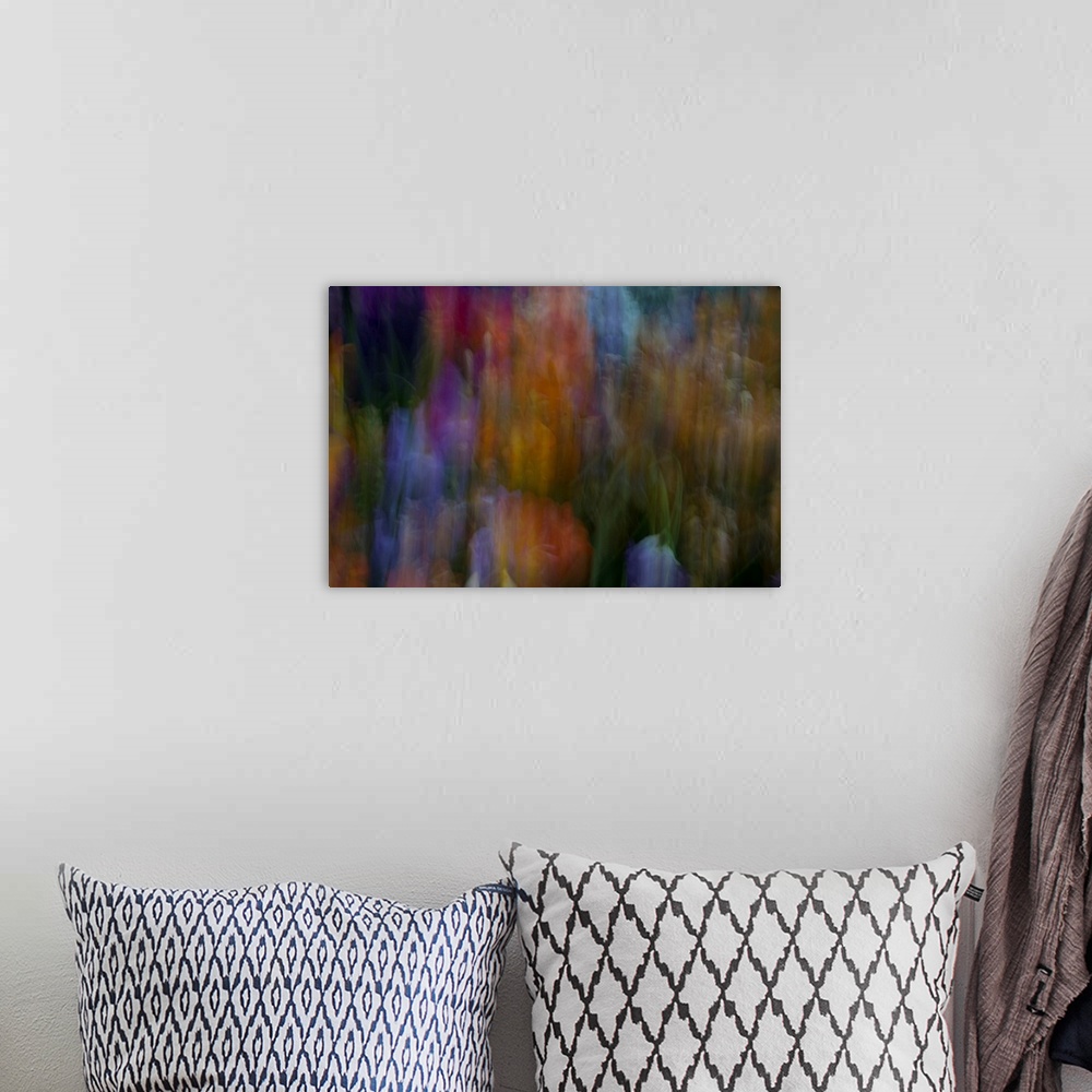 A bohemian room featuring Impressionist photograph of a flower garden.