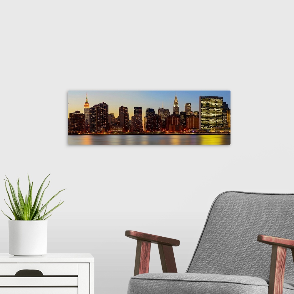 A modern room featuring Manhattan Panoramic View With UN From Long Island City At Night