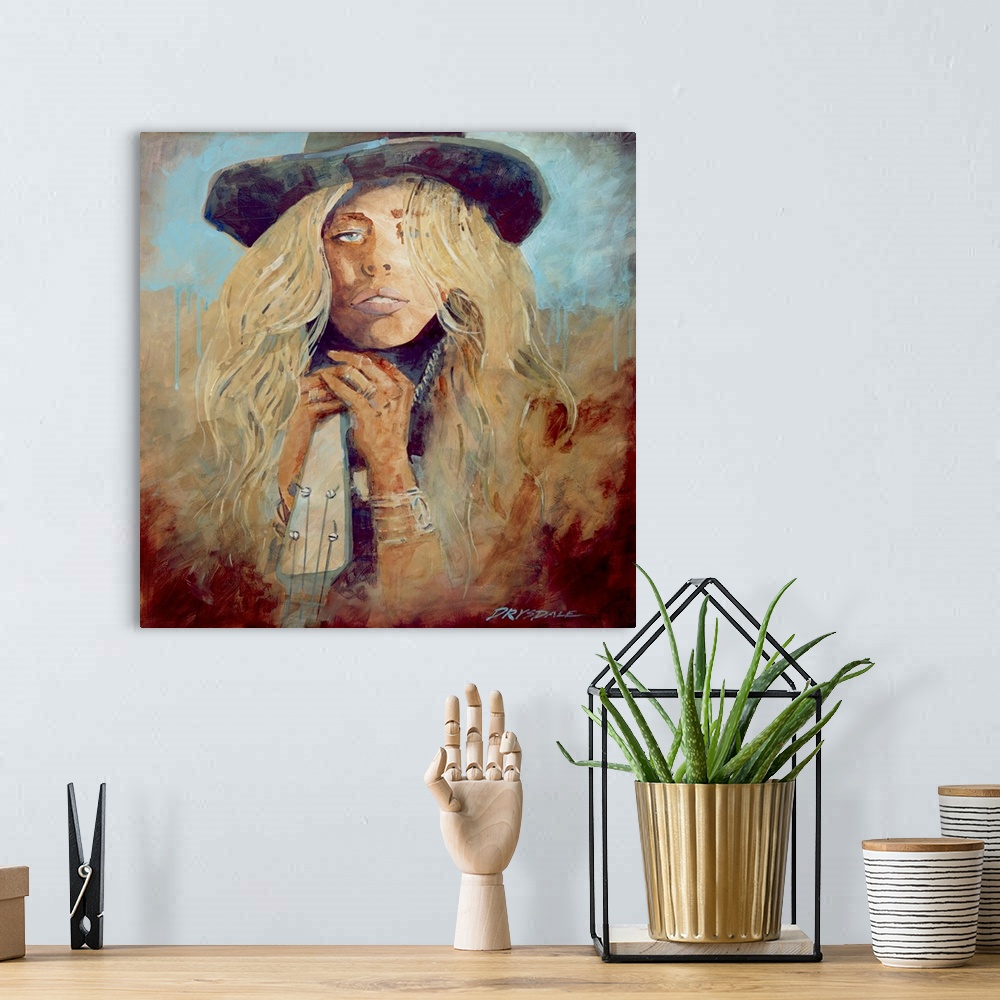 A bohemian room featuring Contemporary painting of a woman in a hat with long blonde hair., leaning against a guitar.