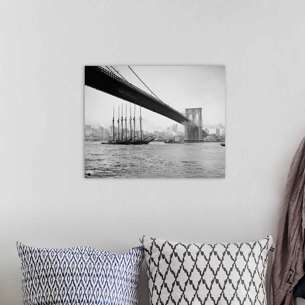 A bohemian room featuring Horizontal, vintage photograph of an old ship passing beneath the Brooklyn Bridge, along the East...