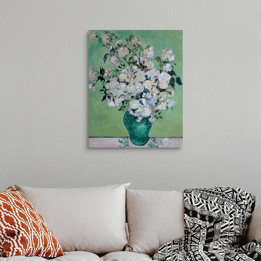 A bohemian room featuring Painting on canvas of flowers in a vase with a few petals on the table it is sitting on.