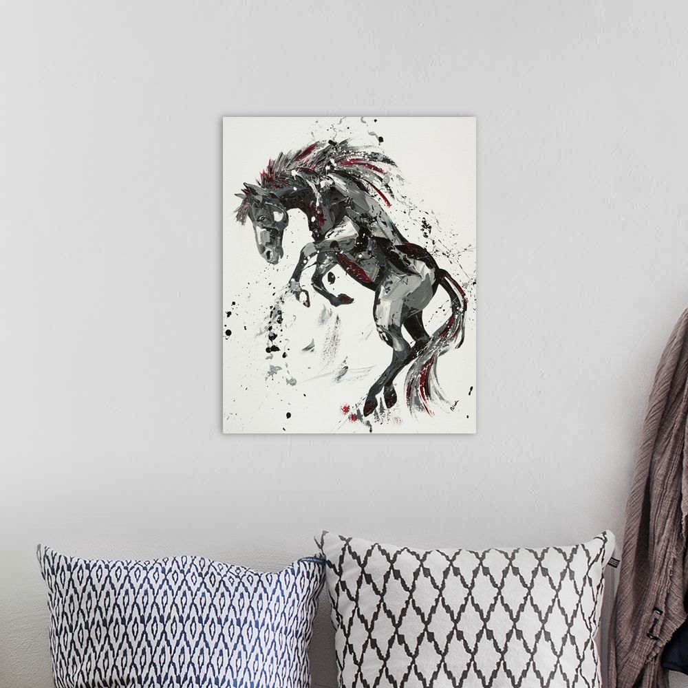 A bohemian room featuring Contemporary painting of a rearing horse in shades of black with red.
