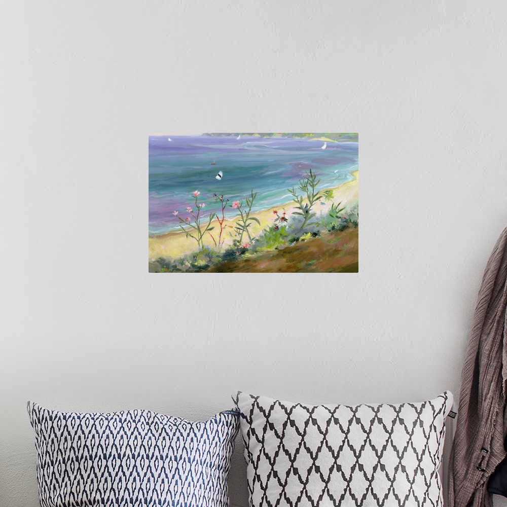 A bohemian room featuring A landscape painting of wildflowers growing along the Grecian shore of a pastel colored sea.