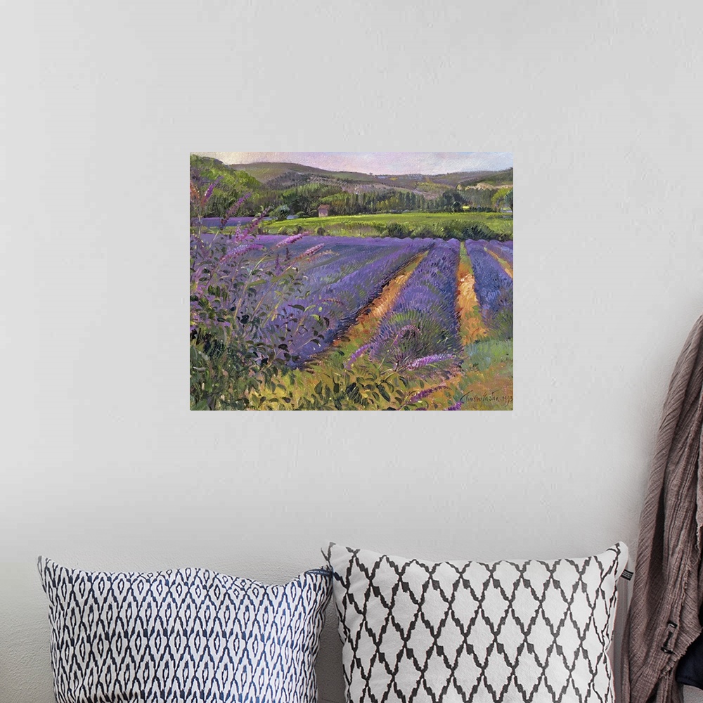 A bohemian room featuring Contemporary artwork of a lavender field that shows the flower close up with trees and hills seen...