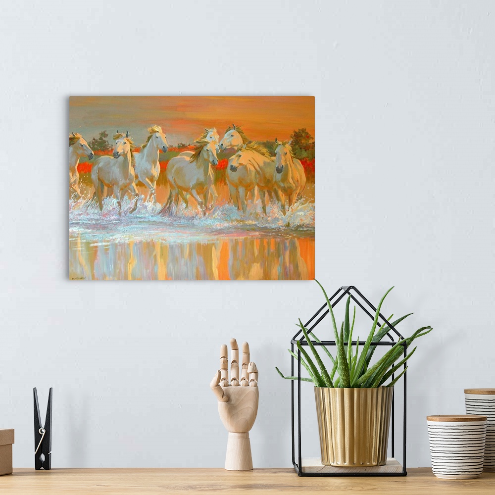 A bohemian room featuring Landscape canvas wall art of wild, white horses galloping through water at sunset.