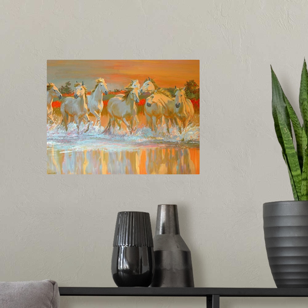 A modern room featuring Landscape canvas wall art of wild, white horses galloping through water at sunset.