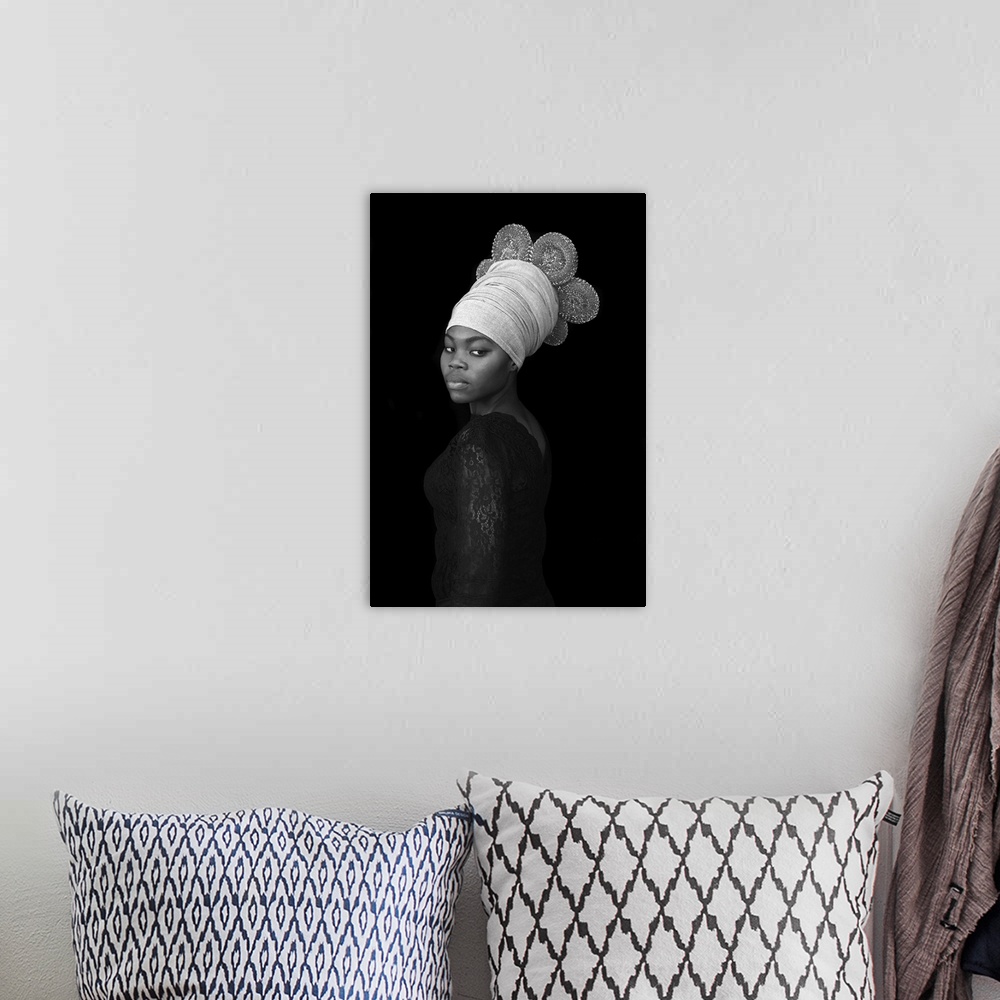 A bohemian room featuring A stunning contemporary black and white portrait of a young Black woman wearing an elaborate wrap...