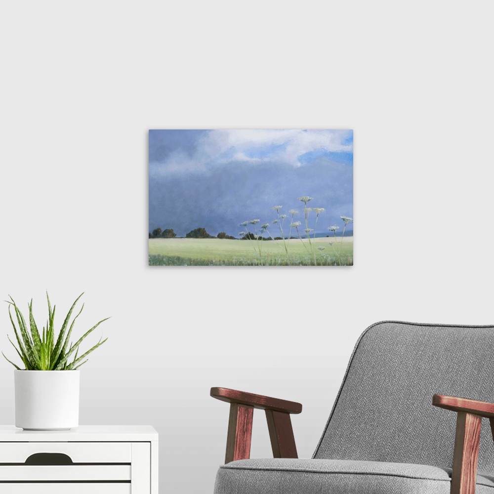 A modern room featuring Contemporary painting of a grassy field with parsley growing under a cloudy sky.