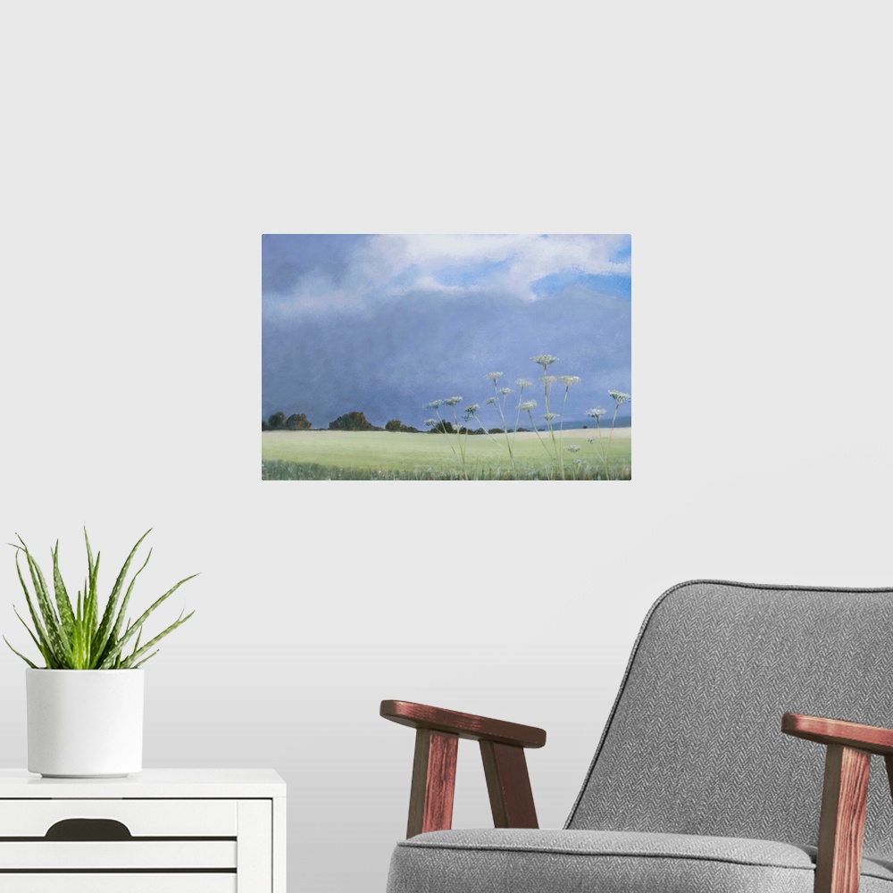 A modern room featuring Contemporary painting of a grassy field with parsley growing under a cloudy sky.