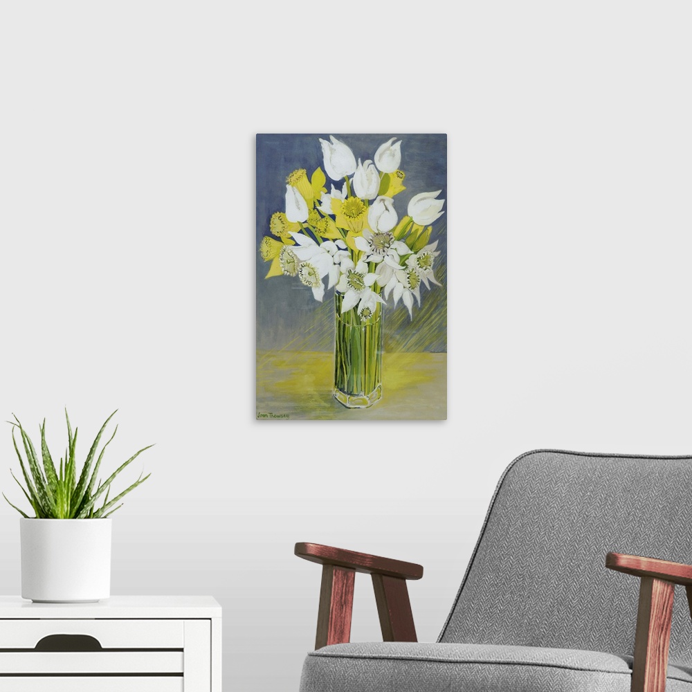 A modern room featuring Daffodils and white tulips in an octagonal glass vase