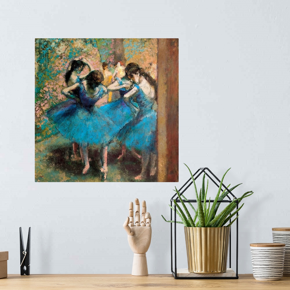 A bohemian room featuring Edgar Degas' famous painting of four ballerinas practicing in the foreground with other figures v...