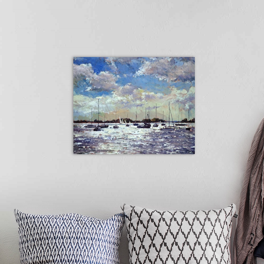 A bohemian room featuring Contemporary art painting of sailboats on the water as the late evening sun shines down between t...