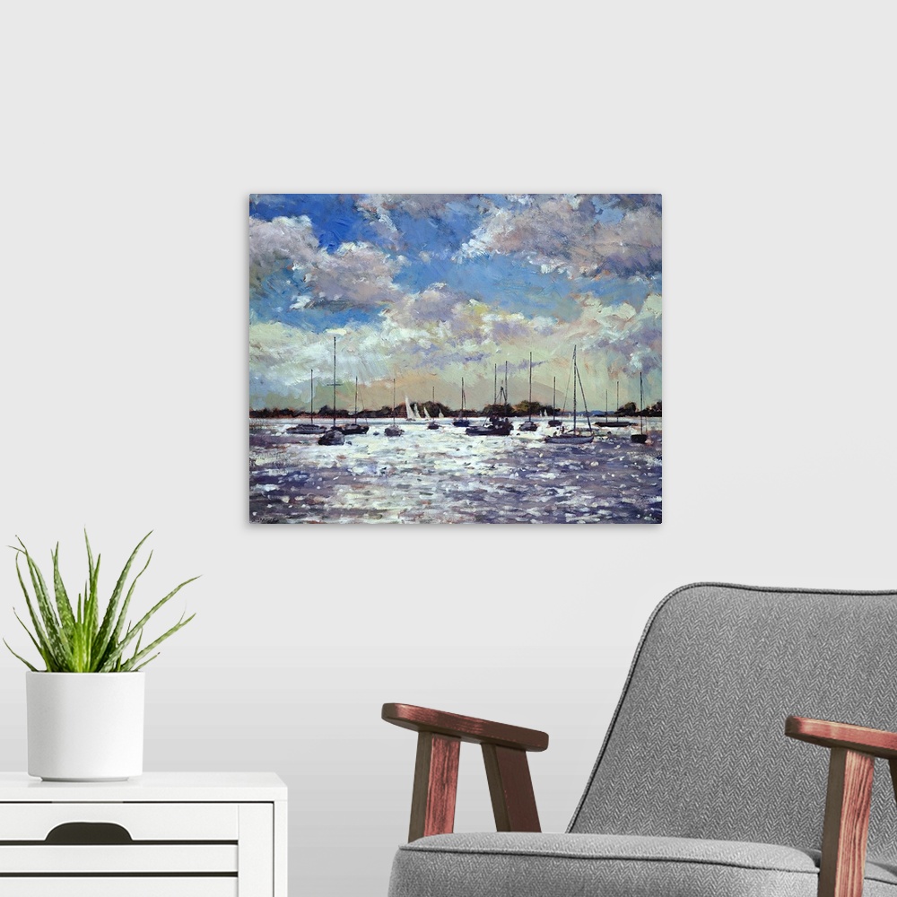 A modern room featuring Contemporary art painting of sailboats on the water as the late evening sun shines down between t...