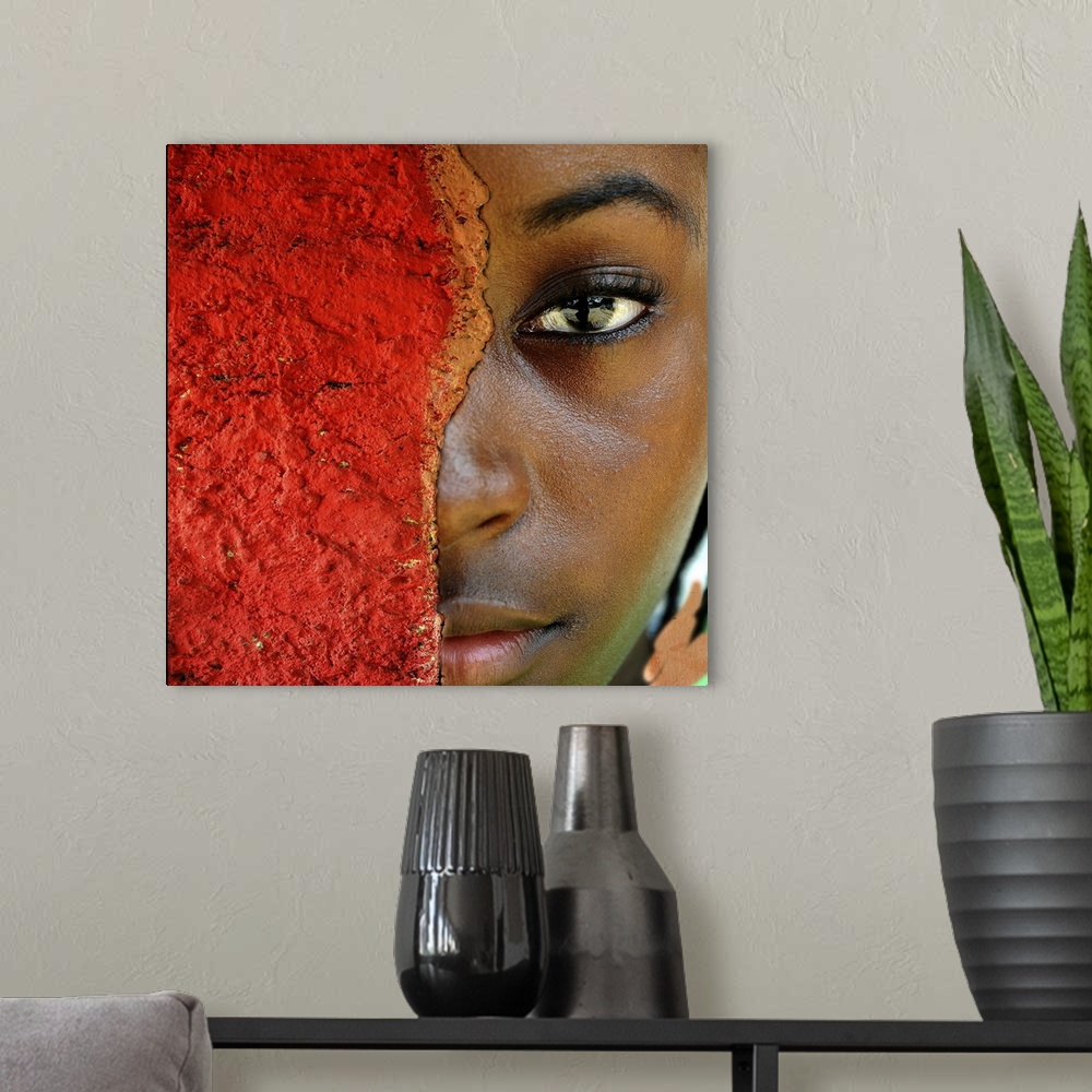 A modern room featuring A stunning contemporary photograph of a Black woman who's face is half hidden by a rusted and pit...