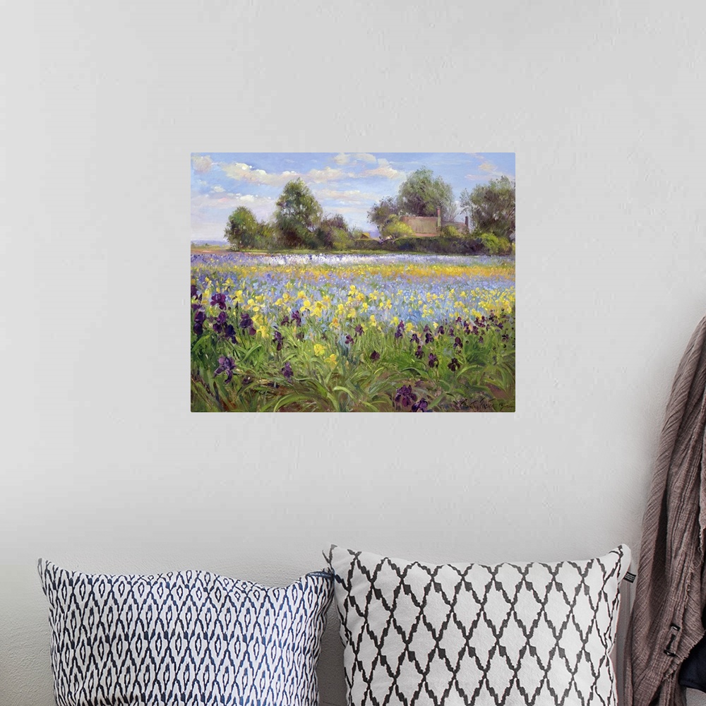 A bohemian room featuring Painting on canvas of a field of wildflowers with a house and trees in the distance.