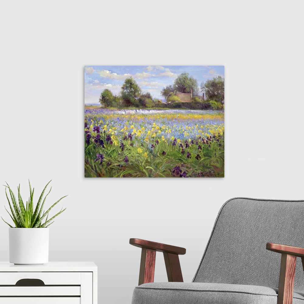 A modern room featuring Painting on canvas of a field of wildflowers with a house and trees in the distance.