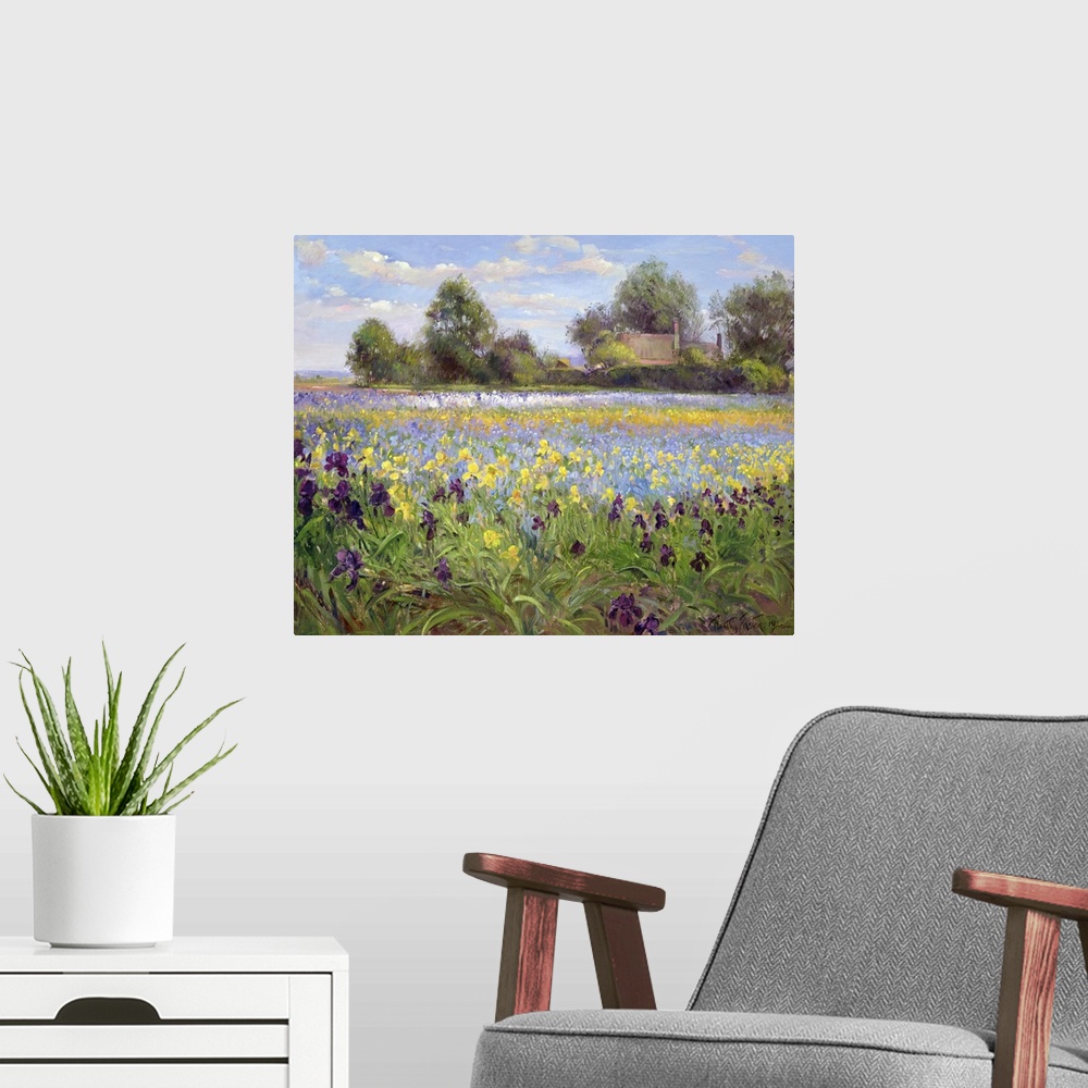 A modern room featuring Painting on canvas of a field of wildflowers with a house and trees in the distance.