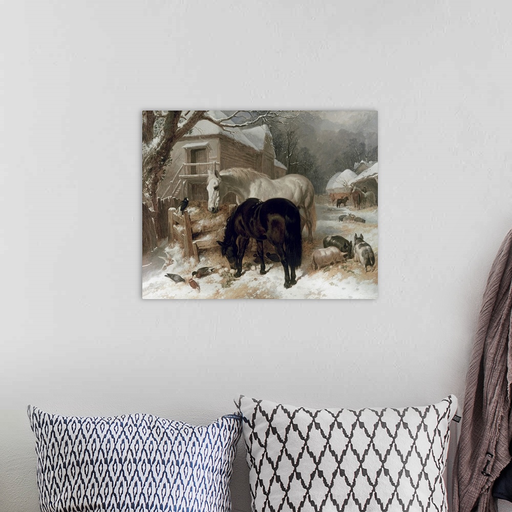 A bohemian room featuring Landscape artwork on a large wall hanging of a snow covered farmyard with several small buildings...
