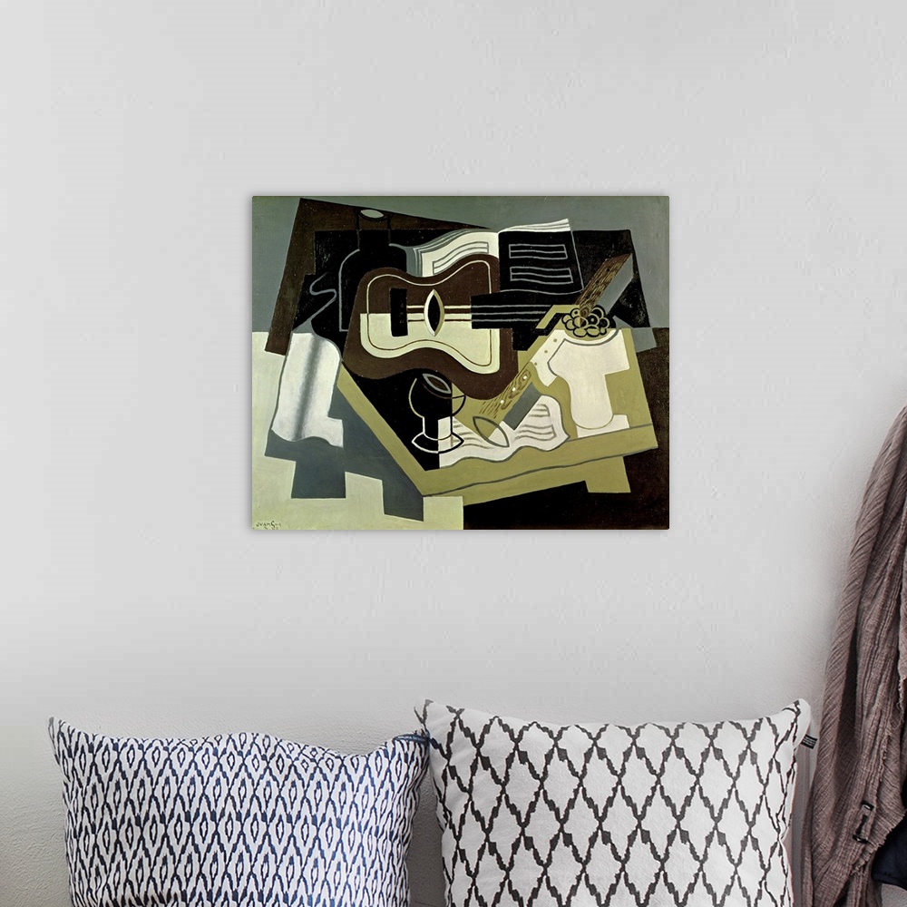 A bohemian room featuring Abstract artwork of a guitar and clarinet with blocks of color patched together behind it.