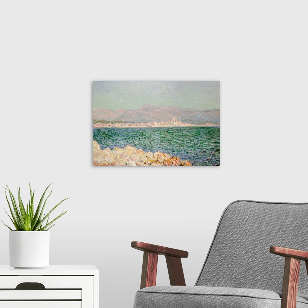 A modern room featuring A piece of classic artwork with water in the foreground and buildings lining the beach behind it....
