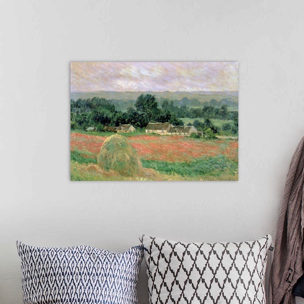 A bohemian room featuring Oil painting of hay bundle in meadow with houses and forest in the distance.