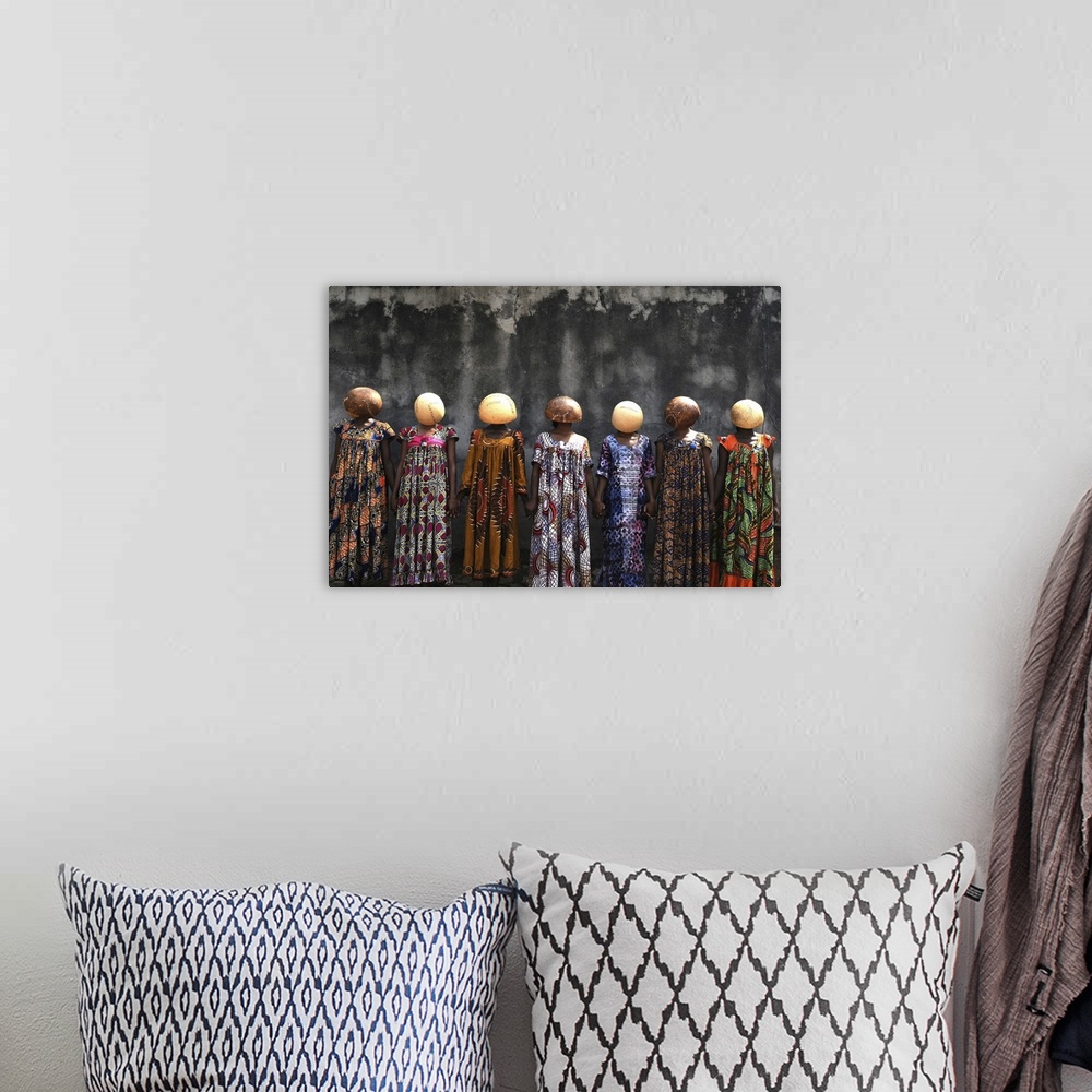 A bohemian room featuring A high-impact fine art photograph of a group of women wearing stitched calabash gourds on their h...