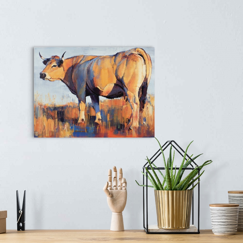 A bohemian room featuring Contemporary painting of a large cow in a field in harsh sunlight.