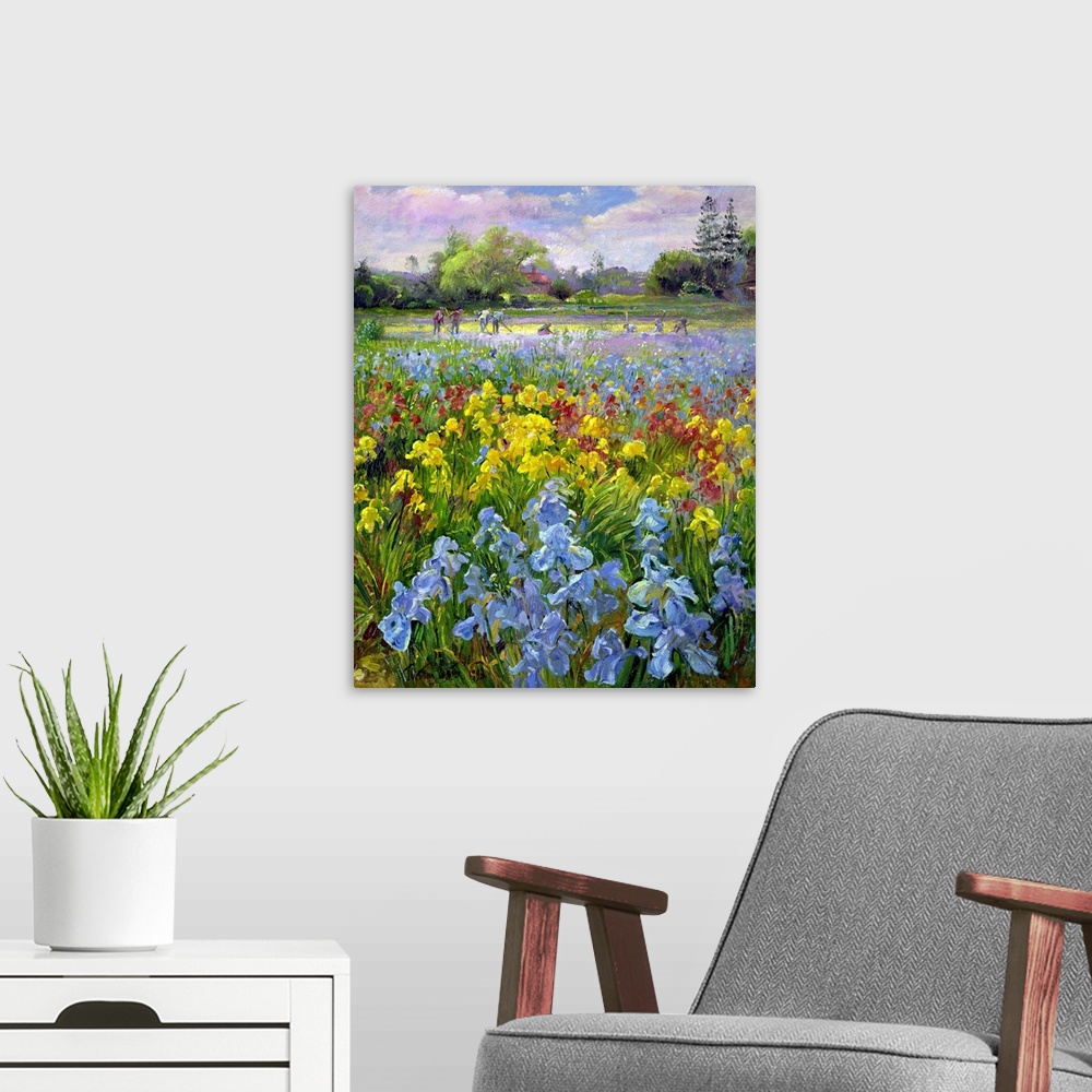 A modern room featuring Vertical, oversized floral painting of a field of multicolored irises, a large group of people in...