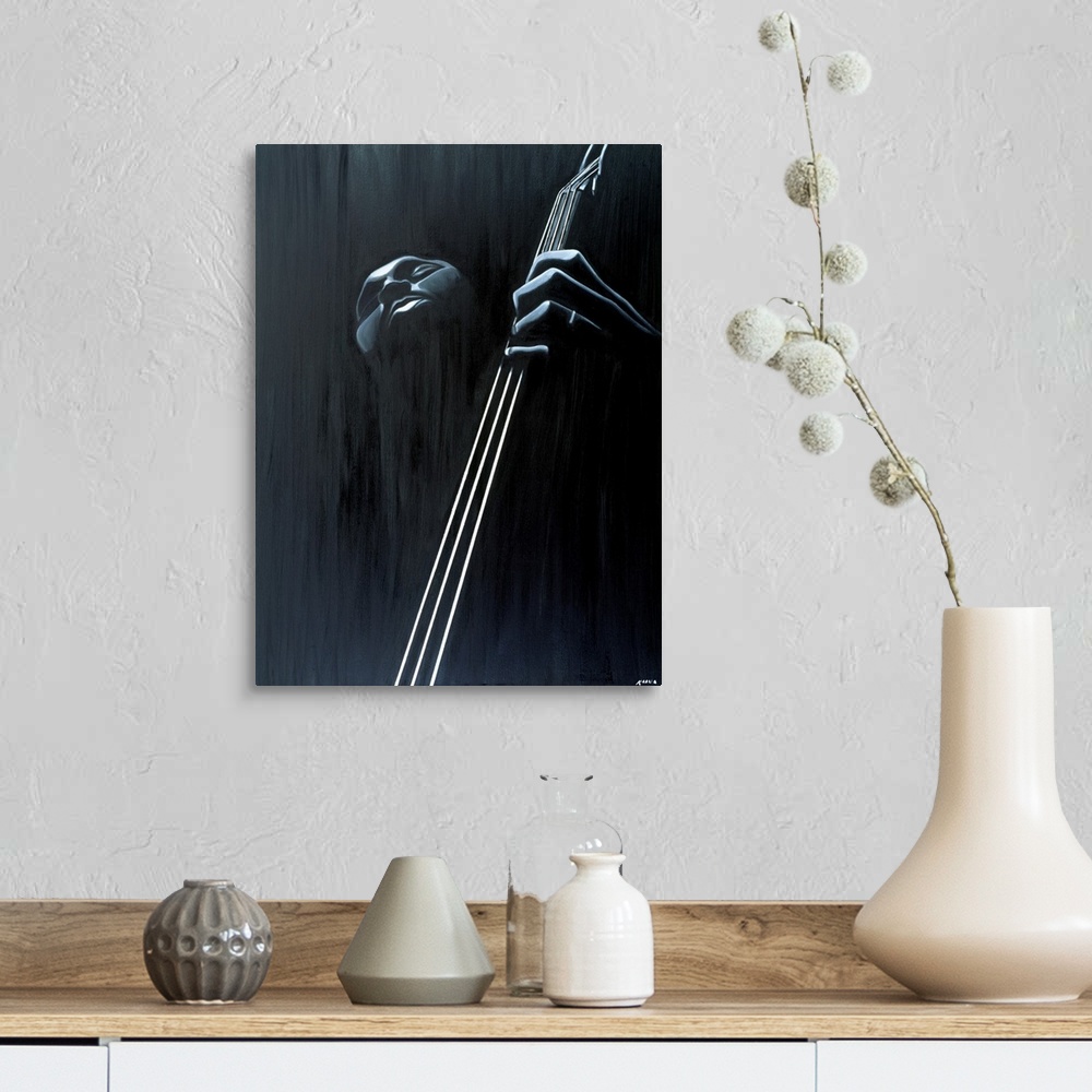 A farmhouse room featuring Big contemporary monochromatic art focuses on a close-up of a man playing the bass against a slig...