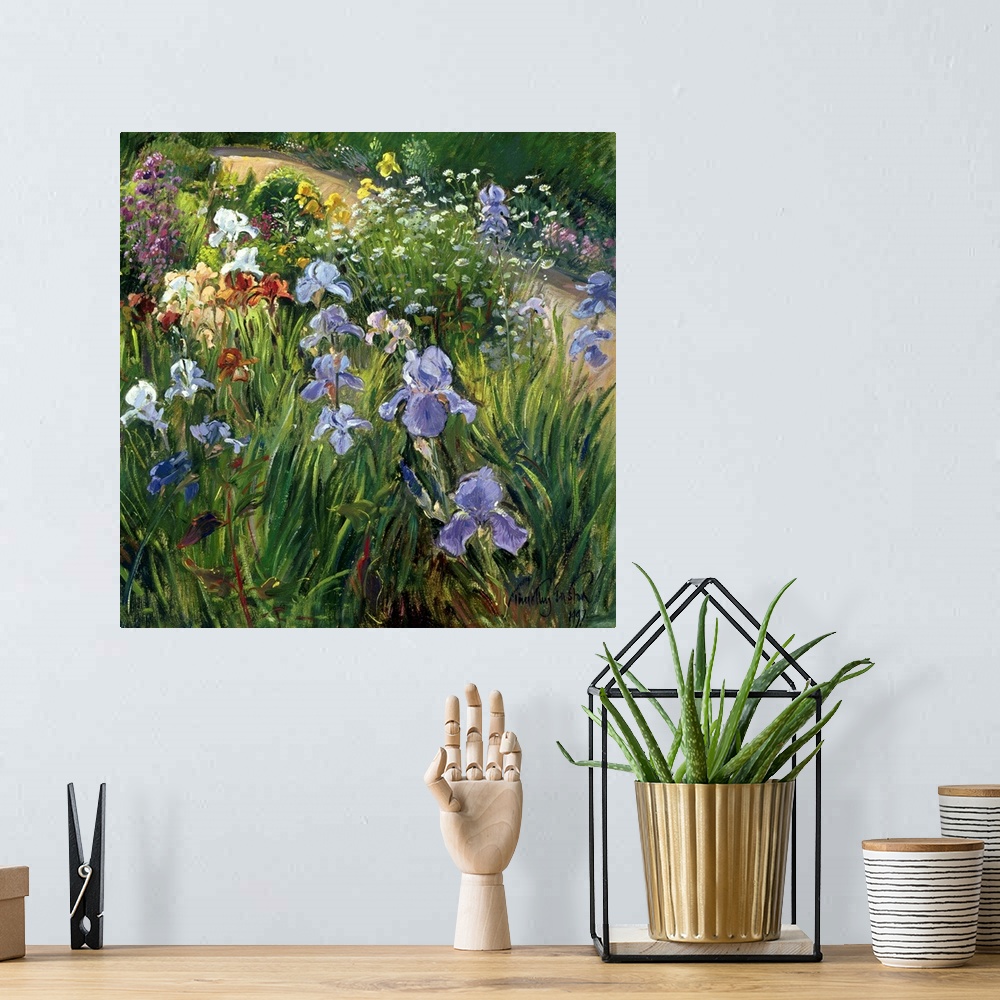 A bohemian room featuring Large square floral art focuses on a variety of flowers at close range that includes irises and o...