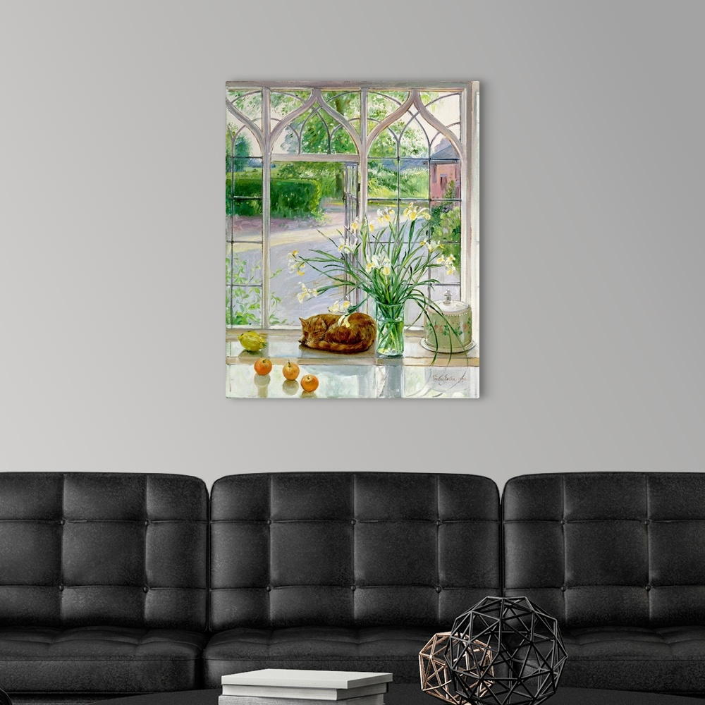 A modern room featuring Contemporary artwork of a large vase of flowers that stands in front of a big window with a cat c...