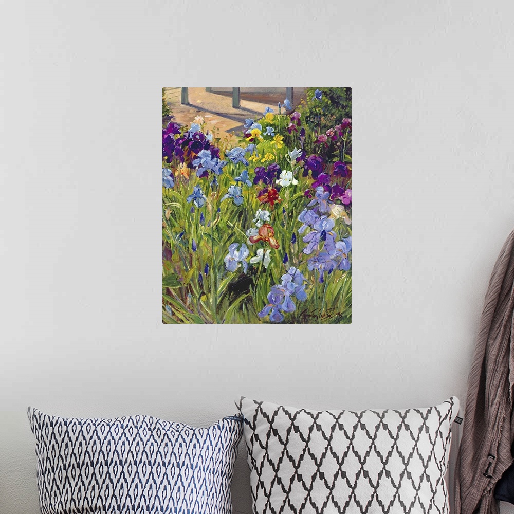 A bohemian room featuring Oil painting by Timothy Easton featuring colorful iris flowers blooming in a garden.