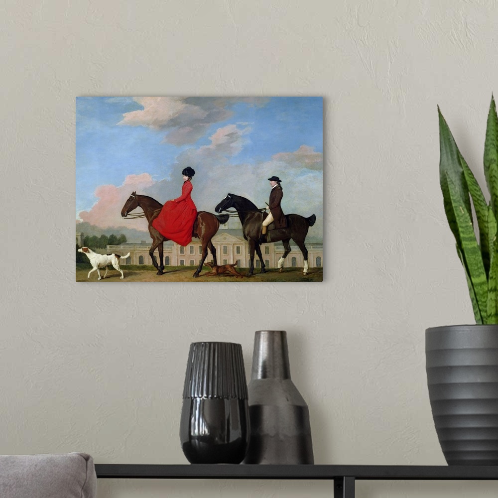 A modern room featuring Classic artwork of a man and a woman riding their horses with their two dogs running along side t...
