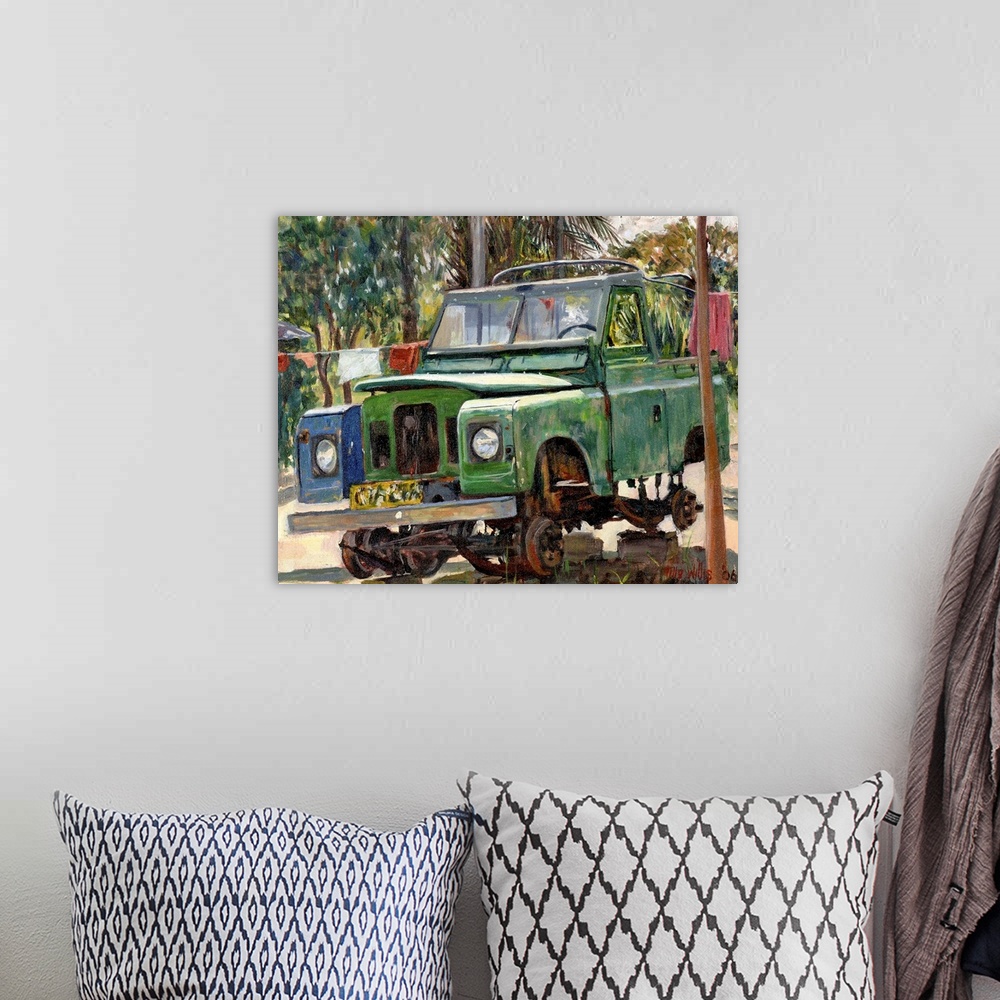 A bohemian room featuring Oil painting of broken down car sitting on blocks with tropical backdrop.