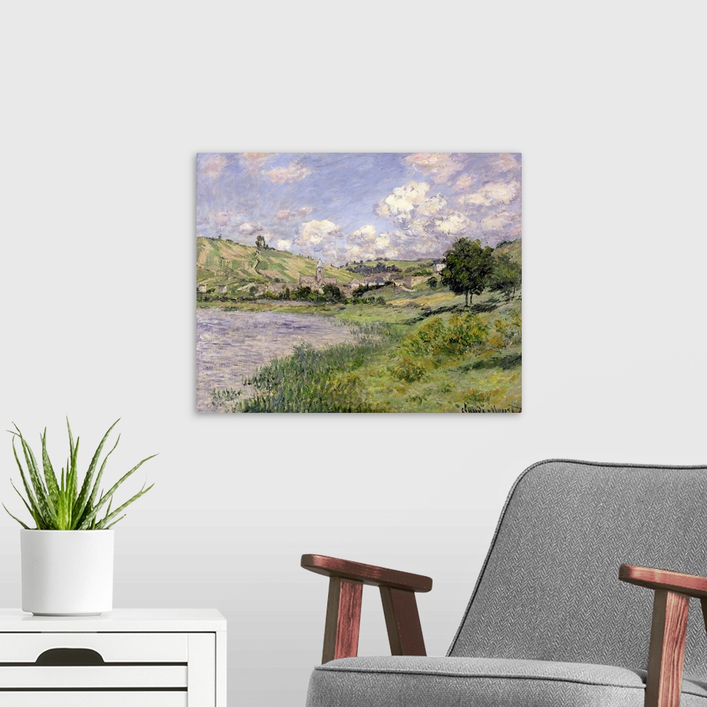 A modern room featuring Oil painting of countryside with rolling hills and lake under a cloudy sky.