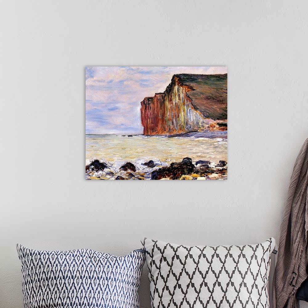A bohemian room featuring Oil painting of rocky shoreline with cliff in the distance under a cloudy sky.