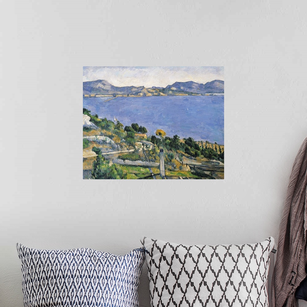 A bohemian room featuring Landscape classic painting of the blue waters of the Bay of Marseilles.  Trees and rocks cover th...