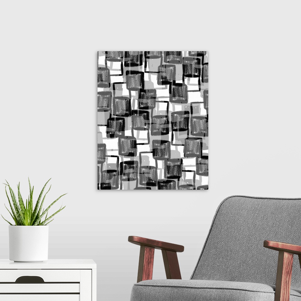 A modern room featuring An abstract piece of artwork that consists of black and grey squares in an erratic pattern.