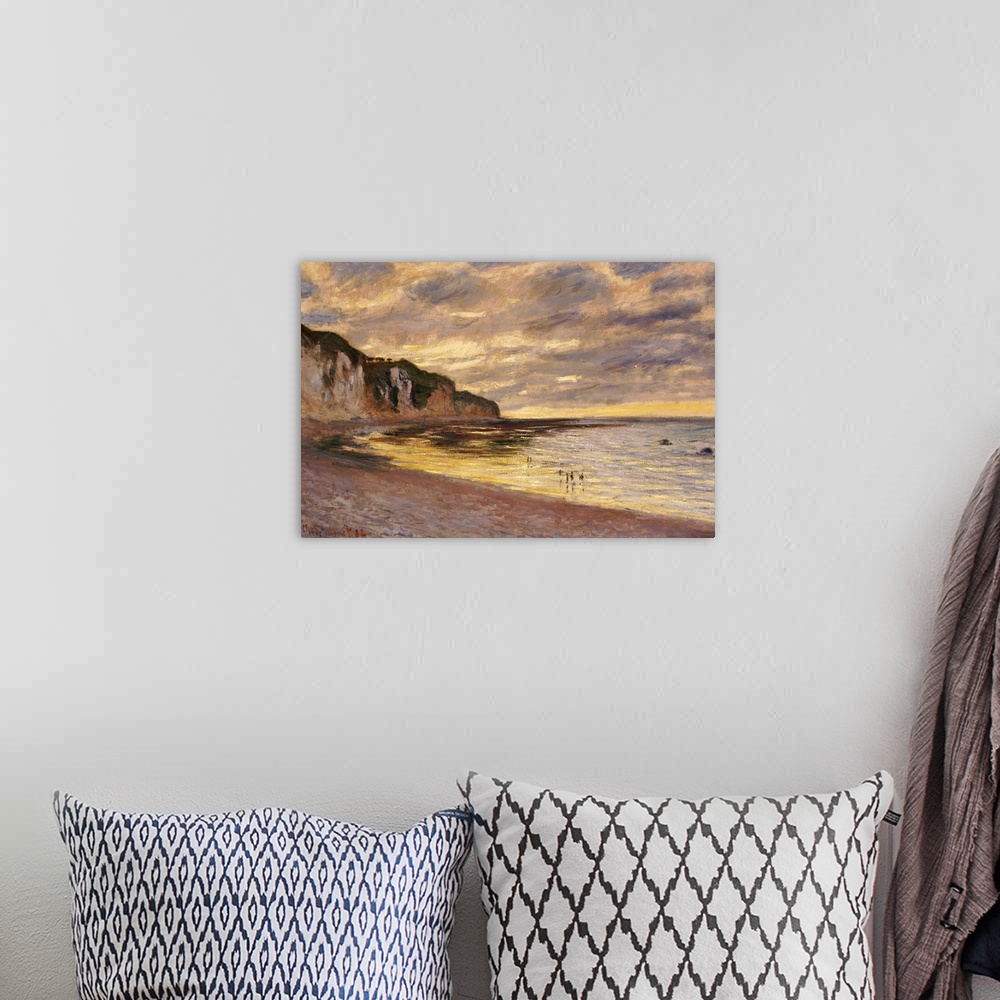 A bohemian room featuring A classic piece of artwork that is a painted beach scene under a dusk sky with cliffs lining the ...